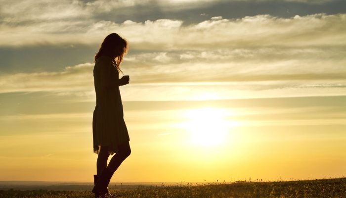 Portrait,Of,A,Woman,Walking,Thoughtfully,At,Sunset